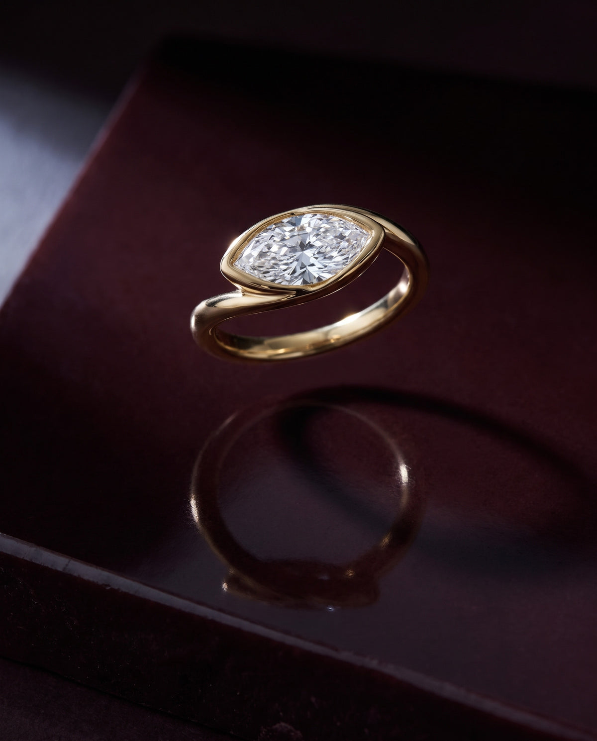 Levendi Wave of Love - Marquise Soft Curve Bezel — Levendi Jewellers, on burgundy stone