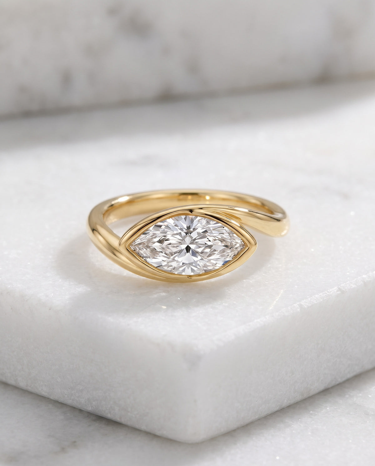 Levendi Wave of Love - Marquise Soft Curve Bezel — Levendi Jewellers, on white Thassos marble