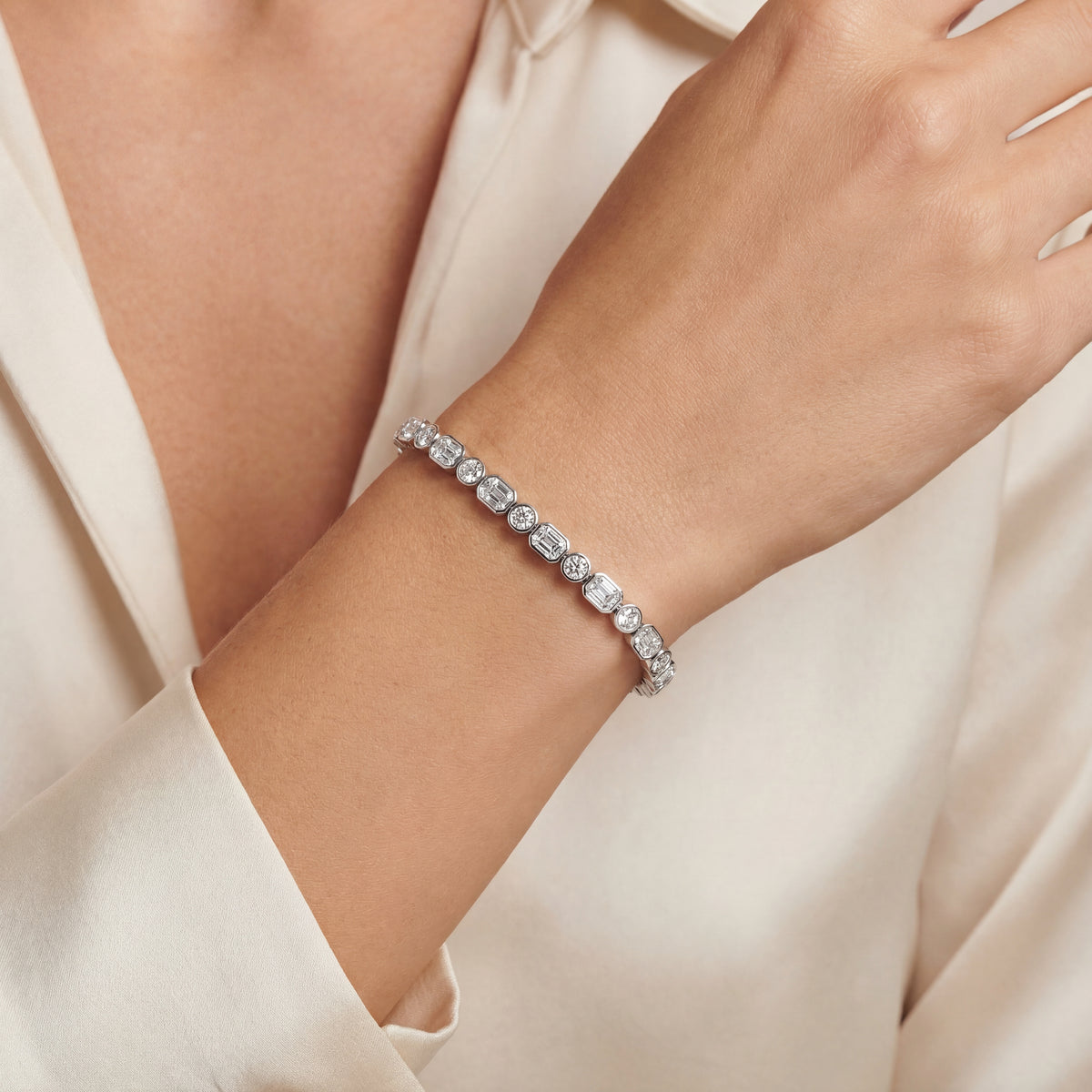 Emerald and Round Brilliant cut diamond bezel set tennis bracelet — Levendi Jewellers