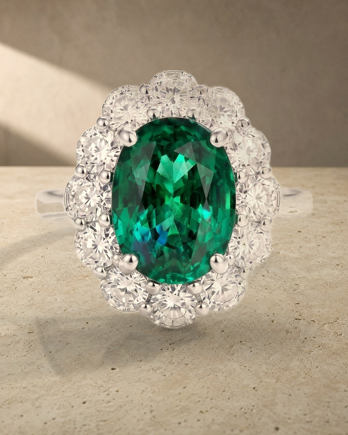 Oval Cut Emerald & Diamond Halo Ring — styled