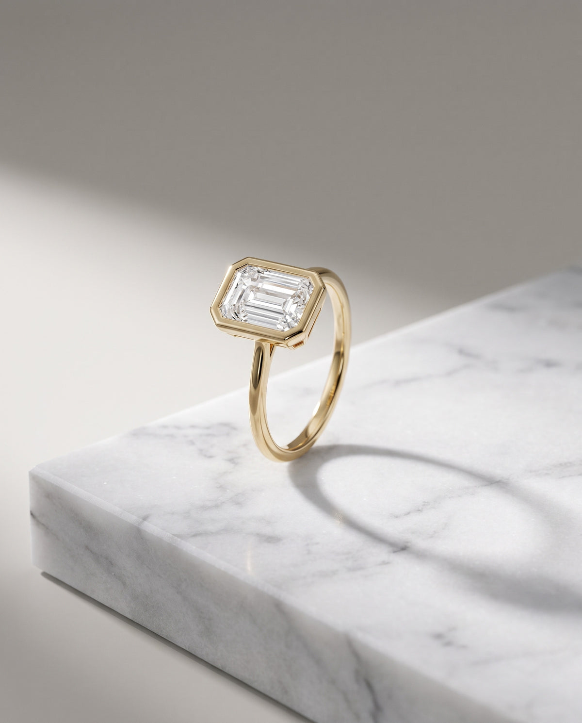 Levendi Wave of Love - Emerald Cut Bezel Engagement Ring — Levendi Jewellers, on stone