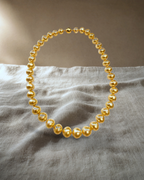 Gold Sea White Strand Necklace Graduated Oval — styled