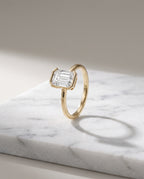 Levendi Wave of Love - Emerald Cut Open Bezel Engagement Ring — Levendi Jewellers, on stone