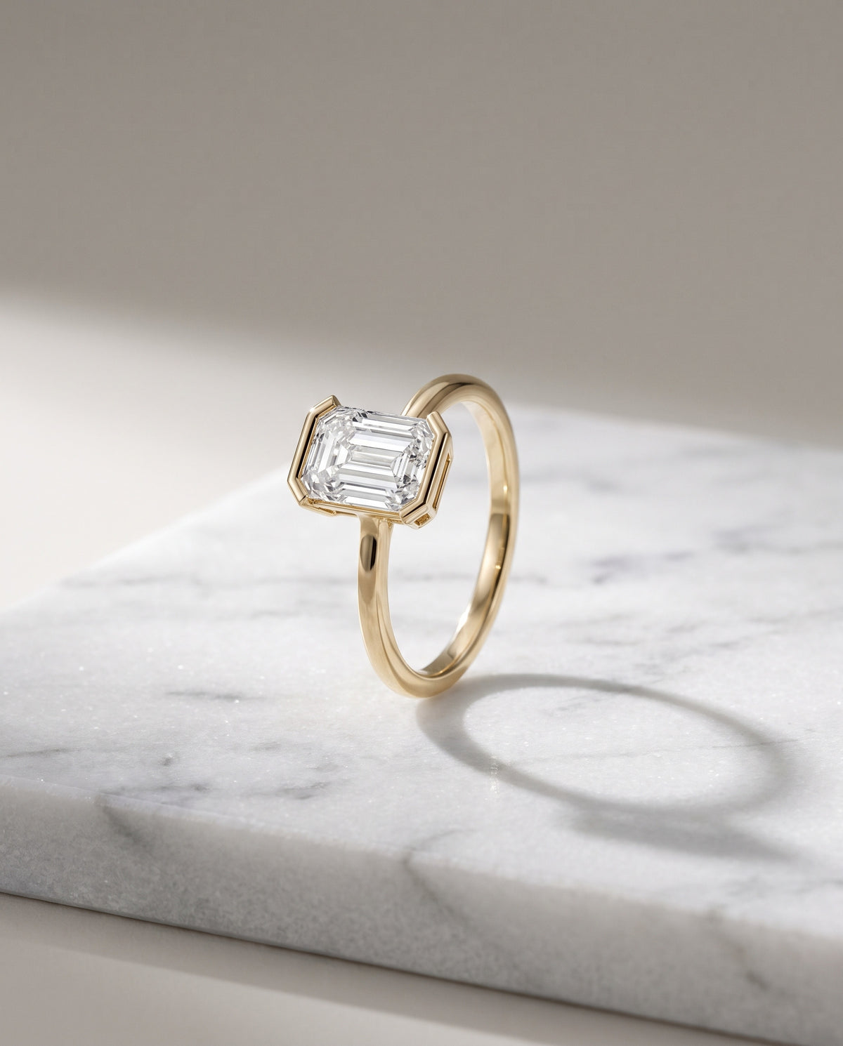 Levendi Wave of Love - Emerald Cut Open Bezel Engagement Ring — Levendi Jewellers, on stone