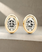 Classic Bezel Oval Cut Diamond Studs Earrings — styled