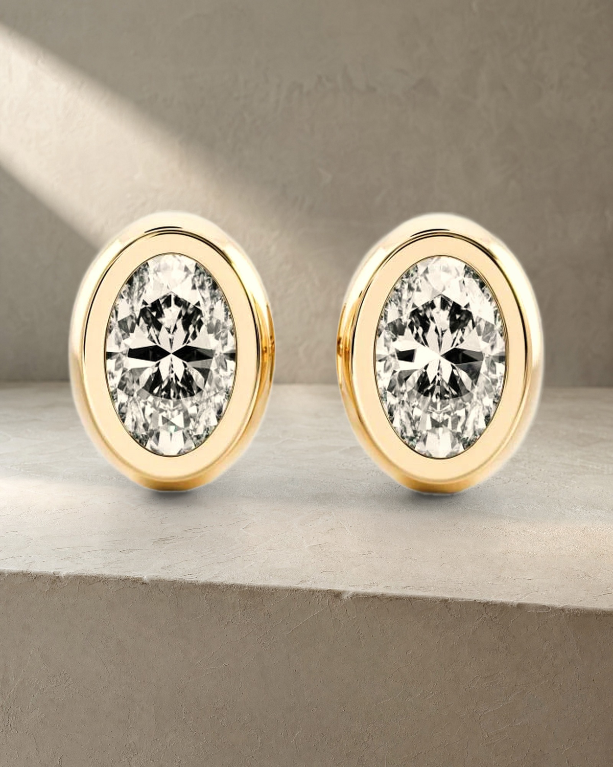 Classic Bezel Oval Cut Diamond Studs Earrings — styled